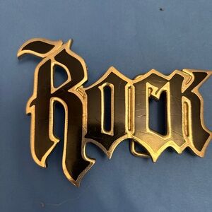 Beautiful vintage belt buckle featuring the word “Rock” in black.